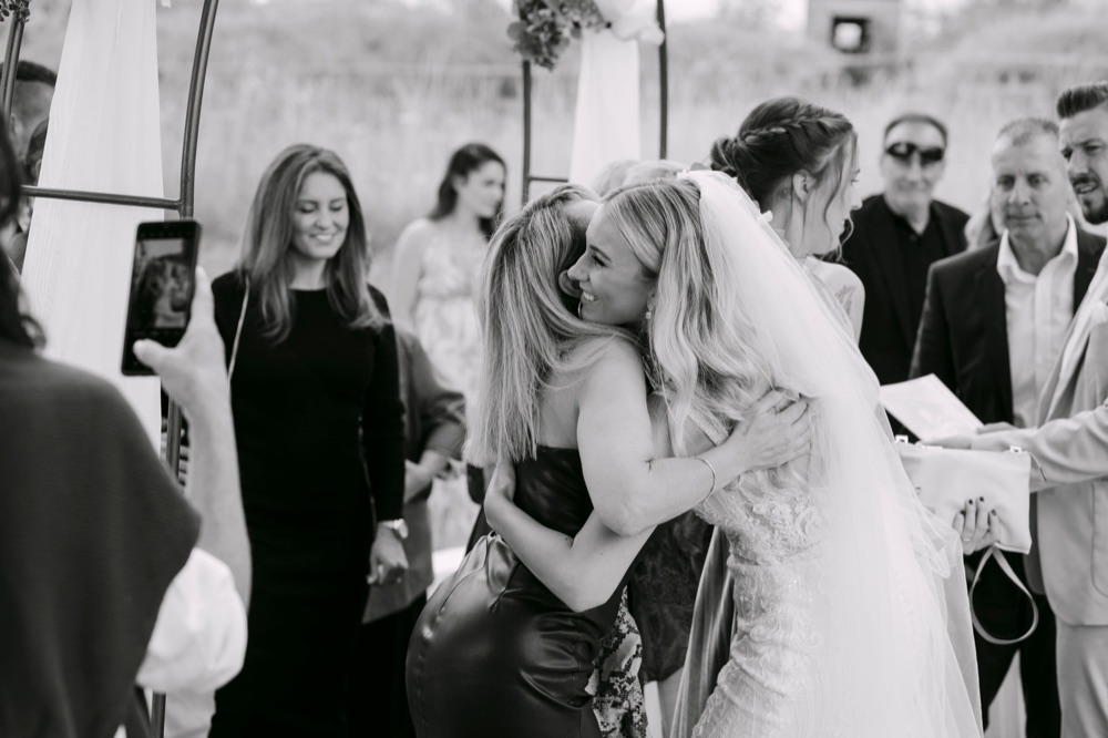 Bride embracing guest during ceremony, vivid documentary wedding moment – Saphir Weddings Kronach Bavaria